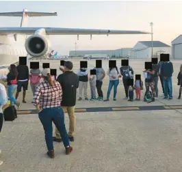  ?? COURTESY ?? Migrants in San Antonio are loaded onto a plane on Sept. 14 to fly to Martha’s Vineyard. This photo was part of a public records release on Oct. 14. Florida officials blocked out the faces of the passengers.