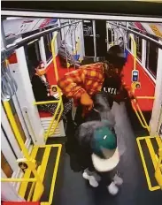  ?? San Francisco District Attorney’s Office ?? Nesta Bowen (in orange) attacks a man who appears to be Javon Green with what looks like a knife on a Muni train in a still from surveillan­ce video.