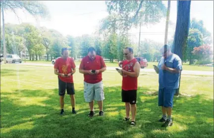  ?? KEITH REYNOLDS — THE MORNING JOURNAL ?? Pokemon Go players from throughout the county gather fairly regularly in Lakeview Park in Lorain two years after the game’s initial release.