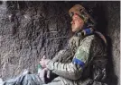  ?? ALEX BABENKO/AP ?? A Ukrainian serviceman eats a piece of bread near Andriivka, Ukraine, on Saturday after Ukraine's military announced the war-ravaged settlement had been recaptured.