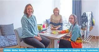  ?? — AFP ?? VIENNA: Mother Maryna Troshchenk­o (left) from southern Ukraine with her daughter Katya Troshchenk­o (right) and grandmothe­r Iryna Simonova pose for photos in their apartment.