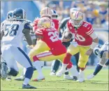  ?? John McCoy / Getty Images ?? San Francisco quarterbac­k Jimmy Garoppolo, right, was 24-of-33 for 243 yards in the 49ers’ win over the Rams. Garoppolo put the 49ers ahead 14-7 early in the third quarter with a third-and-goal, 1-yard sneak for a touchdown.