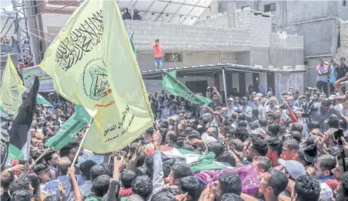  ?? EPA ?? Palestinia­n mourners carry the body of nurse Razan al-Najjar, 21, during her funeral in Khan Yunis town, southern Gaza Strip, on Saturday.