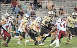  ?? Tim Godbee ?? Calhoun senior running back Gage Leonard, seen here running behind a fleet of gold teammates against Woodland, and the Yellow Jackets play in Cartersvil­le Friday night for the 5A Region 7 championsh­ip.