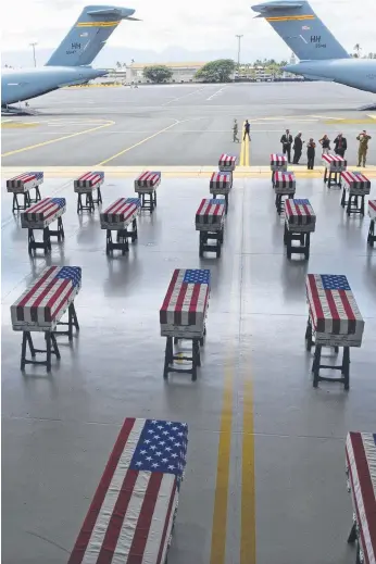  ?? Picture: AFP ?? Flag-draped transfer cases with the remains of American soldiers repatriate­d from North Korea are seen after arriving at Joint Base Pearl Harbor-Hickam, Honolulu.