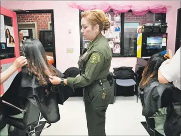  ?? Photograph­s by Christina House Los Angeles Times ?? DEPUTY Brenda Lopez oversees the beauty salon inside the Century Regional Detention Facility in Lynwood.