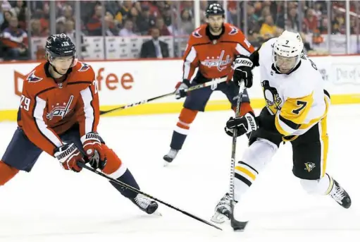  ?? Will Newton/Getty Images ?? Matt Cullen shoots past Washington’s Christian Djoos Wednesday night in the Penguins’ 2-1 loss to the Capitals. The fourth line didn’t score, but it drew praise from general manager Jim Rutherford on Friday: “They were hard to play against,” he said.