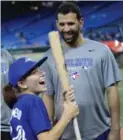  ?? RENE JOHNSTON/TORONTO STAR ?? The Jays’ Jose Bautista surprises fan Sophie Jurus, 13, with a bat Tuesday.