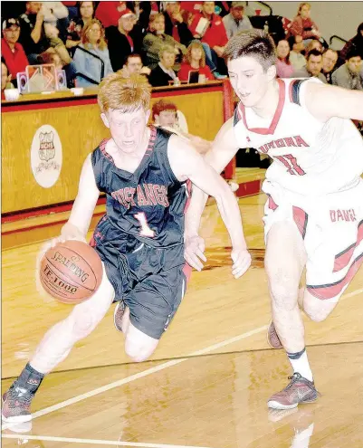  ?? PHOTO BY RICK PECK ?? McDonald County’s Blake Gravette drives past Aurora’s Clayton Dunning during the Mustangs’ 58-26 loss in the semifinals of the Missouri Class 4 District 10 Basketball Tournament on March 2 at MCHS.