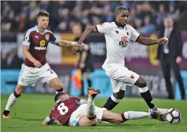  ?? — AFP ?? Watford striker Odion Ighalo ( right) and Dean Marney of Burnley ( centre) vie for the ball in their English Premier League match at Turf Moor in Burnley, England, on Monday. The hosts won 2- 0.