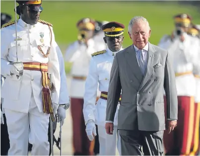  ??  ?? WELCOME: The Prince of Wales views a guard of honour as he arrives at V.C. Bird Internatio­nal Airport in Antigua