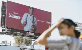  ?? AP FILE PHOTO ?? CHANGING CONCEPTION­S: This May 9, 2018, photo shows a billboard for MedMen, a marijuana dispensary, at an intersecti­on in Los Angeles.