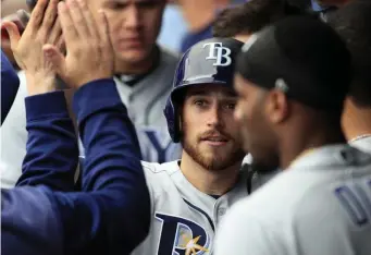  ?? ASSOCIATED PRESS ?? HIGHS AND LOWE: Brandon Lowe is congratula­ted by Rays teammates after homering in the ninth inning of yesterday’s 3-1 win against the Royals.