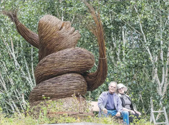  ?? PHOTOS: KIM STALLKNECH­T ?? David and Aubin Van Berckel sit beside a willow sculpture named Con Brio by Vancouver artist Ken Clarke in their 2.5-acre edible garden on Bowen Island.