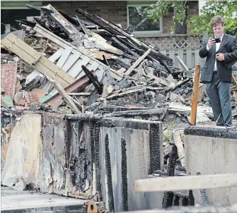  ?? PETER LEE WATERLOO REGION RECORD ?? The investigat­ion of the house explosion at 56 Sprucedale Cres. in Kitchener continued on Monday. The concrete foundation walls are all that remain of the house.