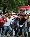  ?? PTI ?? EASY TARGET: Supporters of Gurmeet Ram Rahim Singh attack a member of the media in Panchkula on Friday. —