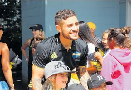  ?? ?? TJ Perenara with young fans at Levin Domain in 2019.