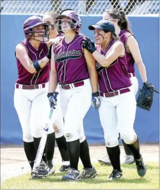  ?? ARNOLD GOLD/HEARST CONNECTICU­T MEDIA ?? Torrington pitcher Ali Dubois, center, is escorted to the dugout by teammates after hitting a home run against Joel Barlow on Saturday.