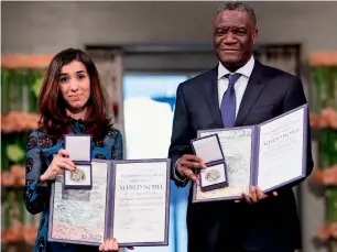  ?? AFP ?? Nobel Peace Prize laureates Yazidi activist Nadia Murad and Congolese doctor Denis Mukwege pose with their Nobel Peace Prizes during the award ceremony at the City Hall in Oslo, Norway. —