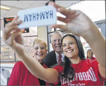  ?? BEN GRAY / BGRAY@AJC.COM ?? Atlanta Public Schools Superinten­dent Meria Carstarphe­n takes a selfie with Gov. Nathan Deal and first lady Sandra Deal at Whitefoord Elementary School in March. Deal’s school reform plan would likely affect Atlanta schools.