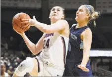  ?? Jessica Hill / Associated Press ?? UConn’s Anna Makurat looks to shoot as Jefferson's Bridget Arcidiacon­o, right, defends during the second half on Sunday.