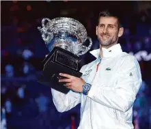  ?? Clive Brunskill/Getty Images ?? Djokovic poses with the Norman Brookes Challenge Cup after earning his 22nd Grand Slam title.
