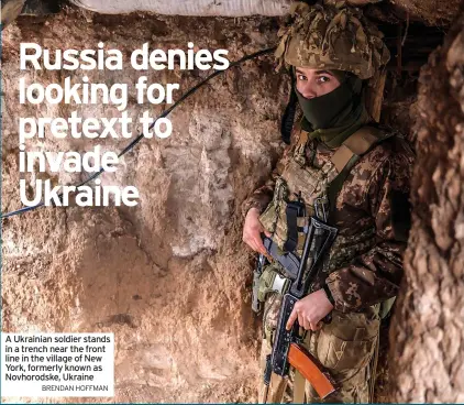  ?? BRENDAN HOFFMAN ?? A Ukrainian soldier stands in a trench near the front line in the village of New York, formerly known as Novhorodsk­e, Ukraine