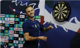  ?? Qatar. Photograph: Tom Jenkins/The Guardian ?? James Maddison plays darts in the media centre after England’s first training session in