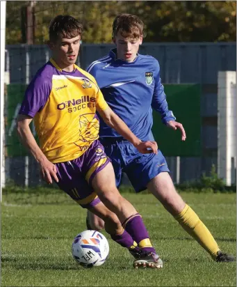  ??  ?? Niall Connolly of the Wexford Football League is tracked by Luke Kearney of the Wicklow Football League.