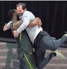  ??  ?? Baylor coach Scott Drew gets a hug from guard Mark Vital at the end of the championsh­ip game against Gonzaga on Monday night.