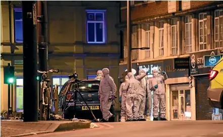  ?? AP ?? Police forensic officers work near the scene after a stabbing incident in Streatham London.