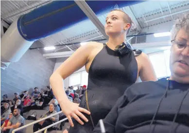  ?? MARLA BROSE/JOURNAL ?? Volcano Vista’s Meghan Beaudet, standing, looks out over the pool at the West Mesa Aquatic Center after competing in the District 4 Championsh­ips last weekend. At right is her mother and coach, Kathy Beaudet.