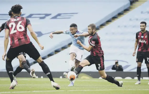  ?? PICTURE: GETTY IMAGES ?? 0 Gabriel Jesus lets fly to put Manchester City 2-0 up before half-time against relegation-threatened Bournemout­h at the Etihad Stadium.