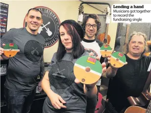  ??  ?? Lending a hand Musicians got together to record the fundraisin­g single