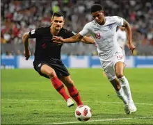  ?? DAN MULLAN / GETTY IMAGES ?? Marcus Rashford of England (right) is challenged by Dejan Lovren of Croatia during Wednesday’s match at Luzhniki Stadium. “Us players, now we change something and everyone is proud of us in Croatia, ” Lovren said.