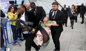  ?? Photograph: Toby Melville/Reuters ?? Security personnel remove a protester from the Fossil Free London demonstrat­ion outside Shell’s AGM.