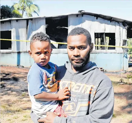  ?? Picture: BALJEET SINGH ?? Pauliasi Matanavutu with son St John Qavili in front of the burnt house in which they were staying at Matawalu, Lautoka.