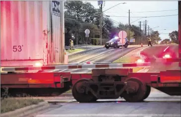  ?? DEBORAH CANNON / AMERICAN-STATESMAN ?? A train sits on tracks Friday at Stassney Lane in South Austin. A Crockett High School student was struck by a train near the campus Friday morning, then taken to St. David’s South Austin Medical Center.