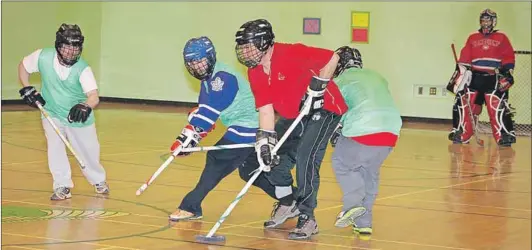  ??  ?? Members of the Kings Special Olympics floor hockey team are shown during a Feb. 9 practice at Central Kings.