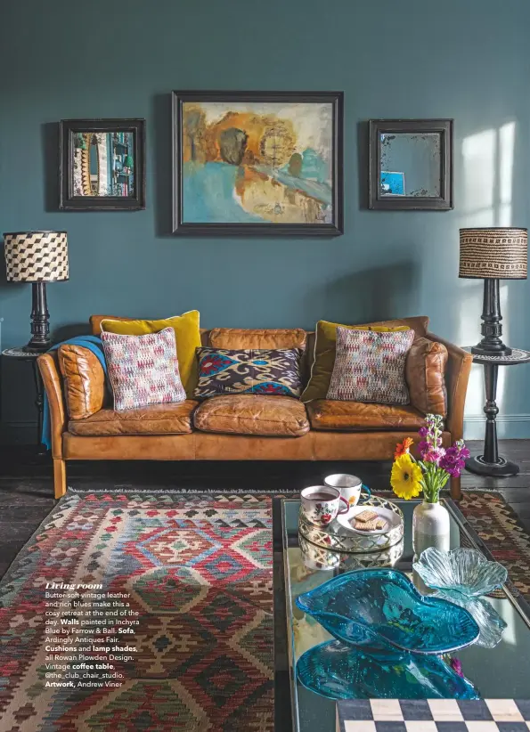  ??  ?? Living room
Butter-soft vintage leather and rich blues make this a cosy retreat at the end of the day. Walls painted in Inchyra Blue by Farrow & Ball. Sofa, Ardingly Antiques Fair. Cushions and lamp shades, all Rowan Plowden Design. Vintage coffee table, @the_club_chair_studio. Artwork, Andrew Viner