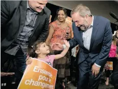  ?? JUSTIN TANG/THE CANADIAN PRESS ?? Tom Mulcair greets a young supporter at a rally in Ottawa earlier this month. The NDP leader has taken to smiling during photo ops to soften his persona.