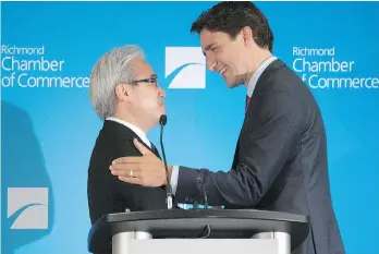  ??  ?? Justin Trudeau greets Paul Oei at a luncheon in Richmond, B.C., on July 24, 2015. Investors say Oei, a prominent immigratio­n consultant, used photos of himself with Trudeau to prove his political clout.