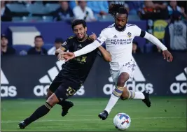  ?? PHOTO BY RAUL ROMERO JR. ?? Galaxy forward Raheem Edwards, right, pushes off Los Angeles FC forward Carlos Vela during the first half of a U.S. Open Cup round of 16match at Dignity Health Sports Park.