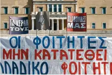  ?? ?? Banners reading ‘Their profits vs Our studies’ and other slogans are seen in front of Parliament during a student protest against the establishm­ent of private universiti­es, in Syntagma Square, downtown Athens, on Thursday.