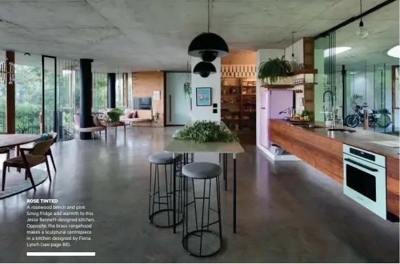  ??  ?? ROSE TINTED A rosewood bench and pink Smeg fridge add warmth to this Jesse Bennett-designed kitchen. Opposite: the brass rangehood makes a sculptural centrepiec­e in a kitchen designed by Fiona Lynch (see page 88).