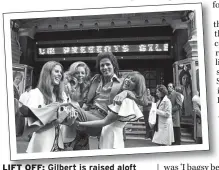  ??  ?? Gilbert is raised aloft by three of his co-stars outside the London Palladium in 1973