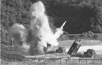  ??  ?? This handout photo taken on July 5, 2017 provided by South Korean Defence Ministry in Seoul shows US M270 Multiple Launch Rocket System firing an MGM-140 Army Tactical Missile into the East Sea from an undisclose­d location on South Korea’s east coast...