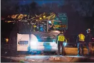  ?? KEVIN HAGEN/AP PHOTO ?? A bus that was carrying teenage passengers sits on the side of a highway after it hit an overpass Sunday night on the Southern State Parkway in Lakeview, N.Y. The bus was carrying teenagers returning from a spring break trip.