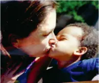  ??  ?? Author Susan Silverman shares a tender moment with her adopted son Adar
