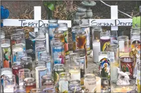  ?? (AP/Richard Vogel) ?? Candles and crosses are placed as a memorial for the children. Authoritie­s have identified 3-year-old Joanna Denton Carrillo, her 2-year-old brother, Terry, and 6-month-old sister, Sierra, as the three young children who were killed.